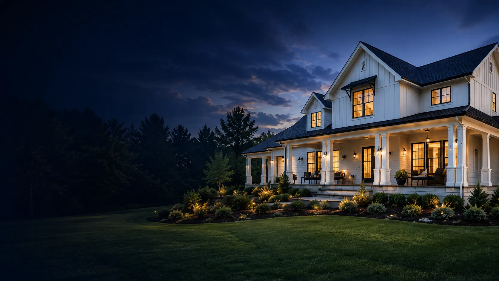 Beautifully painted home at dusk with warm porch lighting